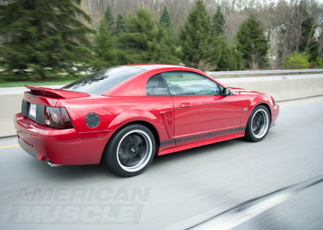 Red SN95 1999-2004 Mustang on the Road